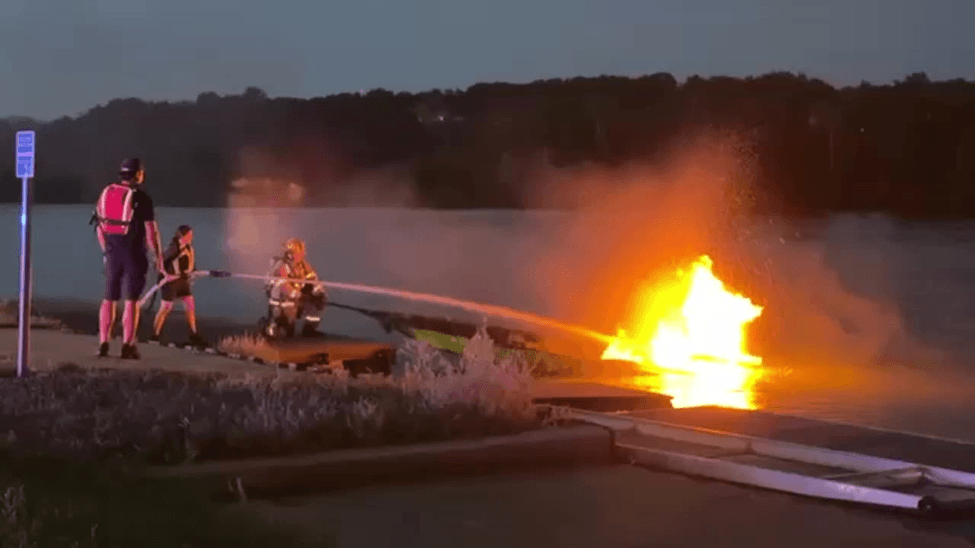 Firefighter putting out a fire on a boat