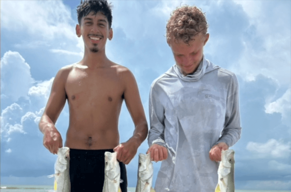 2 Guys holding fish