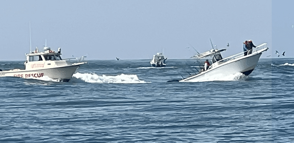 Rescue boats helping another boat