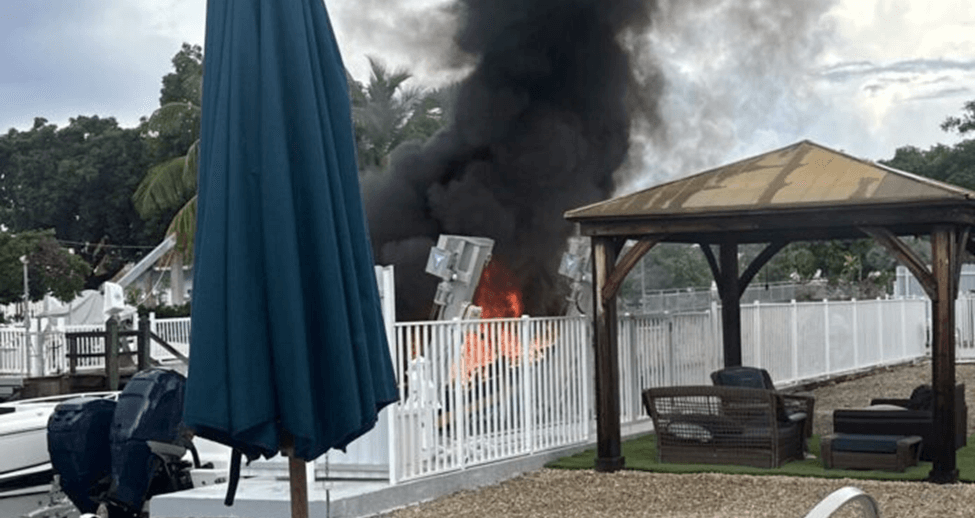 Boat on fire at the dock.