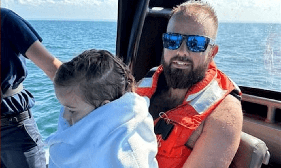Man and daughter being rescued on a boat