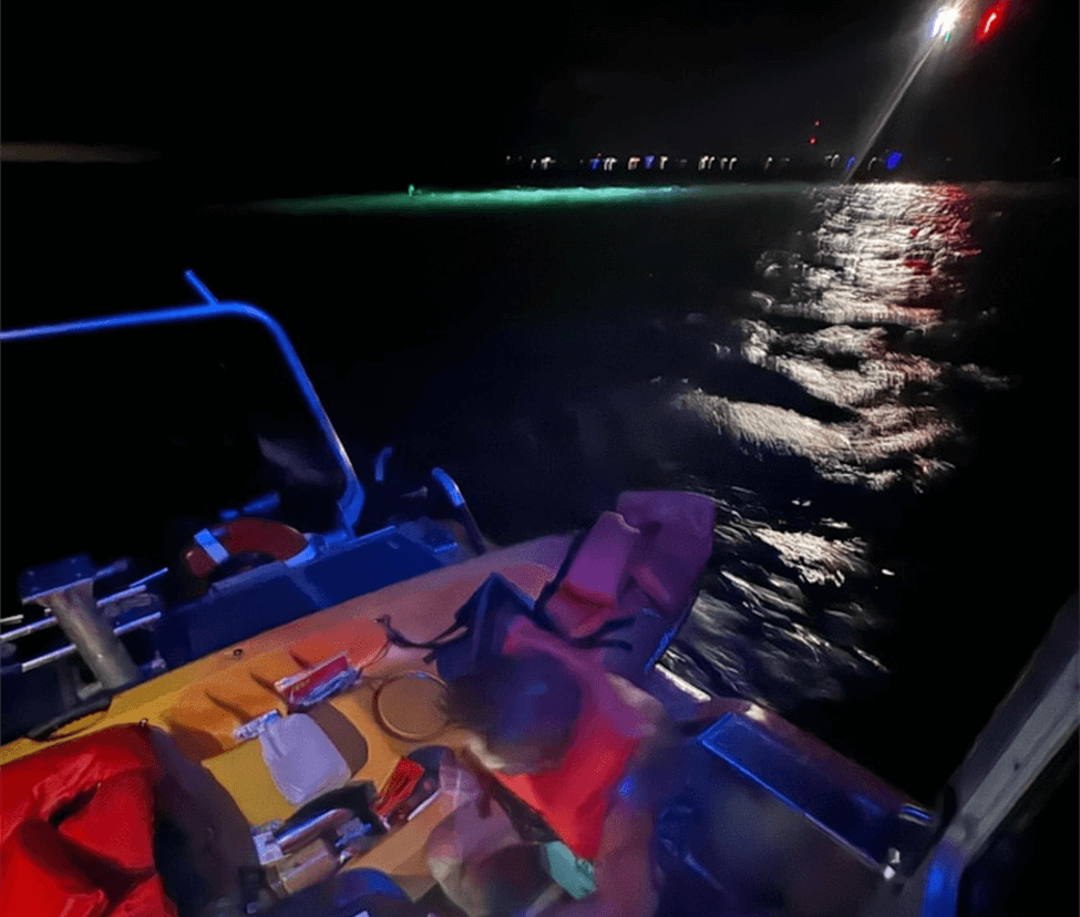Man on boat in water at night