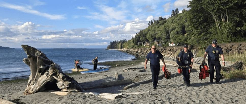 Firefighters walking on a beach