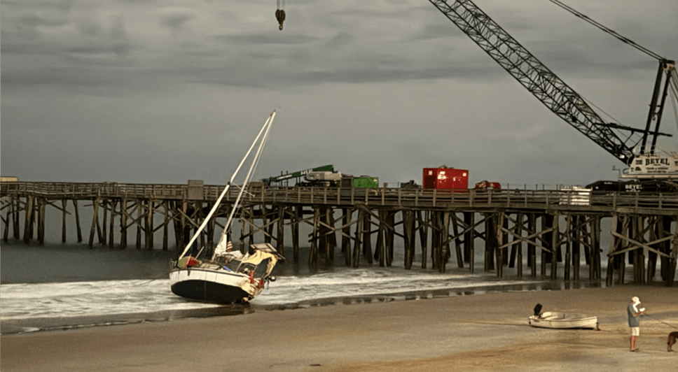 Sailboat stranded in sand.