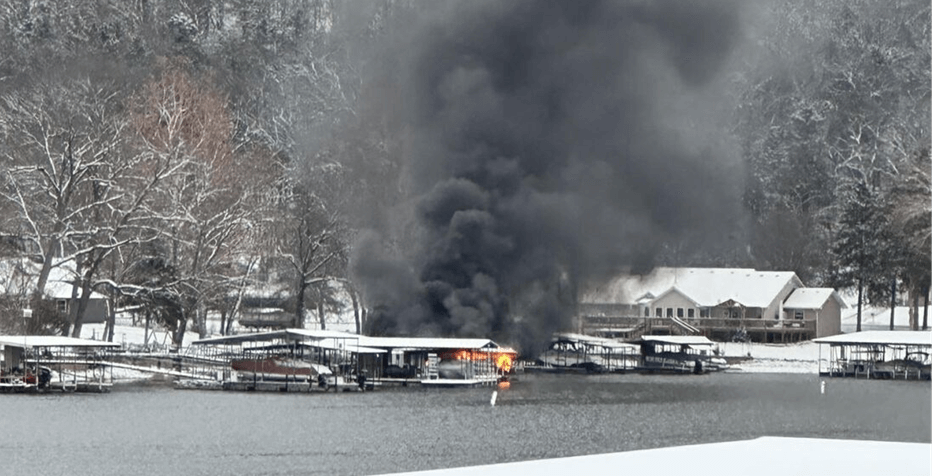 Boat on fire at a dock.