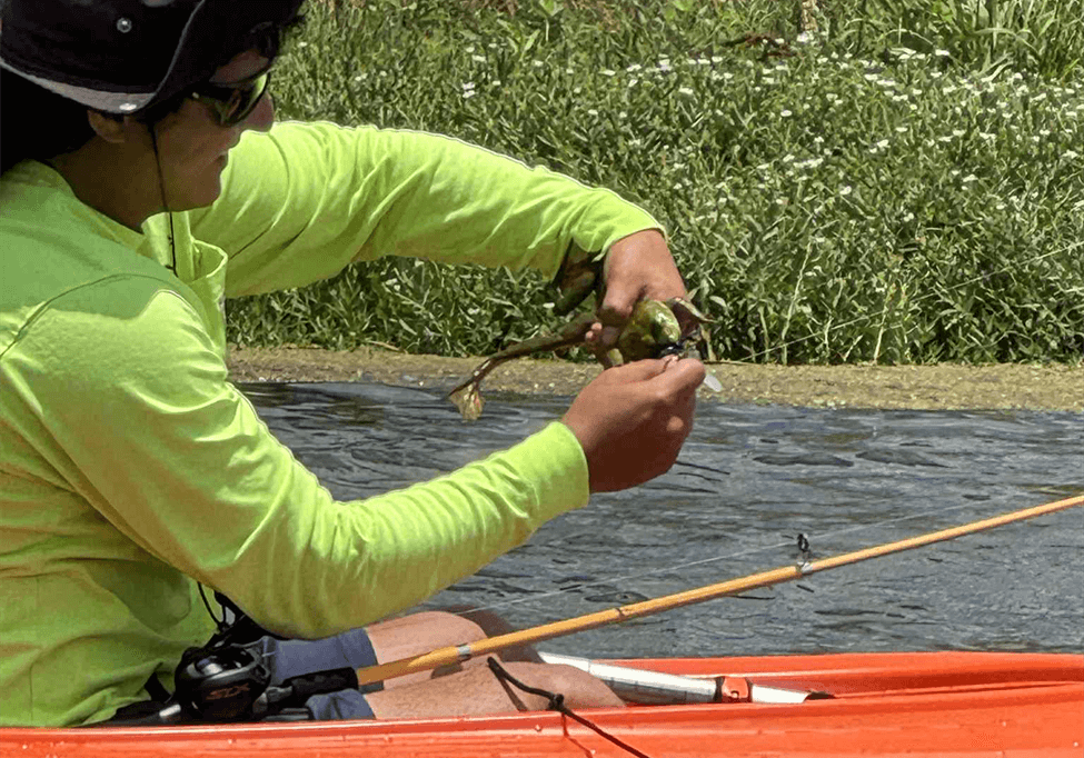 Main in a Kayak holding a frog