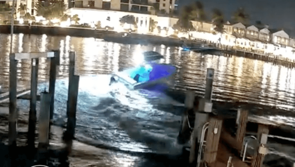 Boat leaving a dock at night