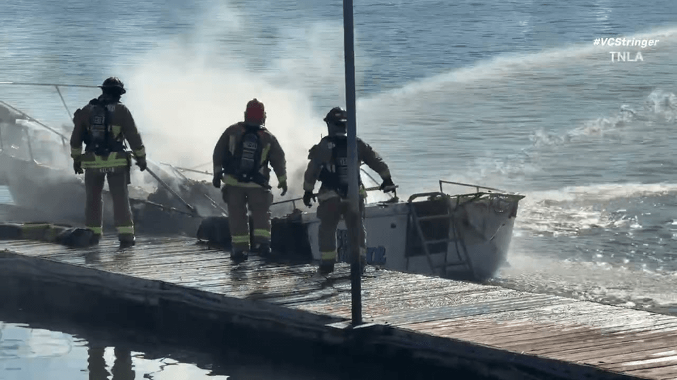 Firefighters extinguishing a fire on a boat