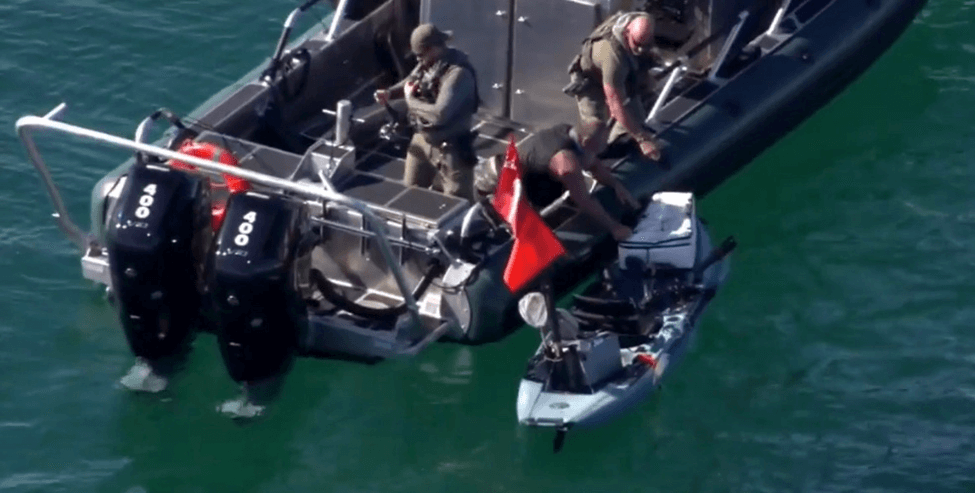 Kayaker being rescued.