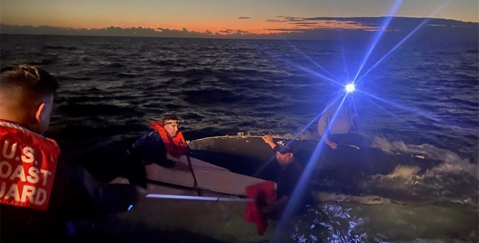 People being rescued from a capsized boat