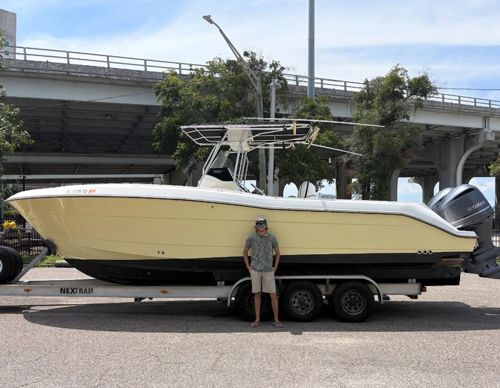 Captain Will Sanchelli in front of his boat