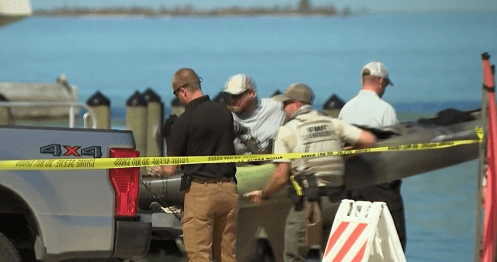 Men puuting Kayak in back of truck