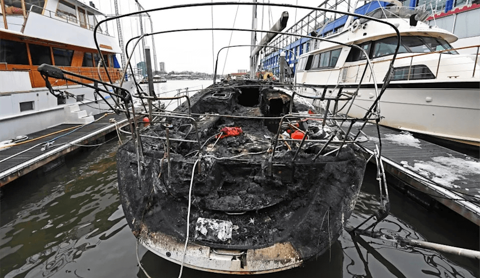 Burned boat at a dock