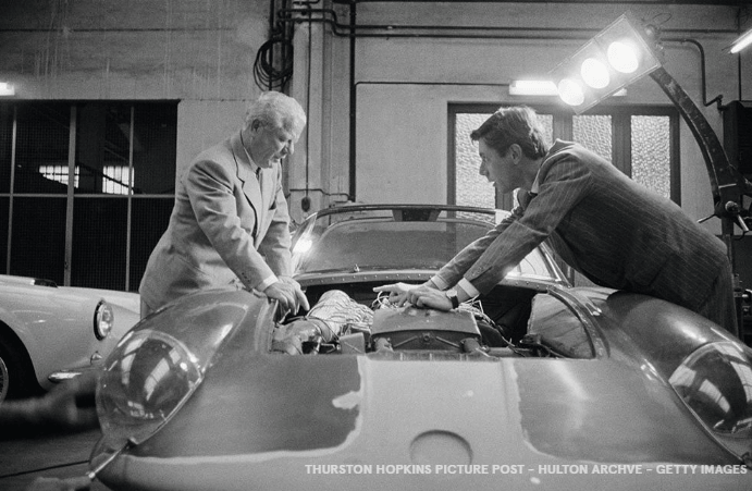 Men overlooking vintage car