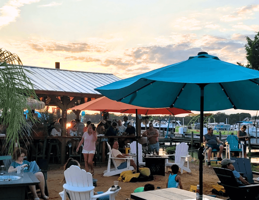 people sitting outside under umbrellas