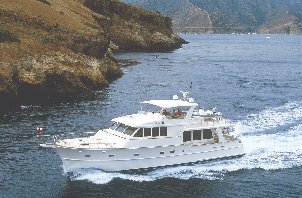 boat running on water with landscape of grassy mountains