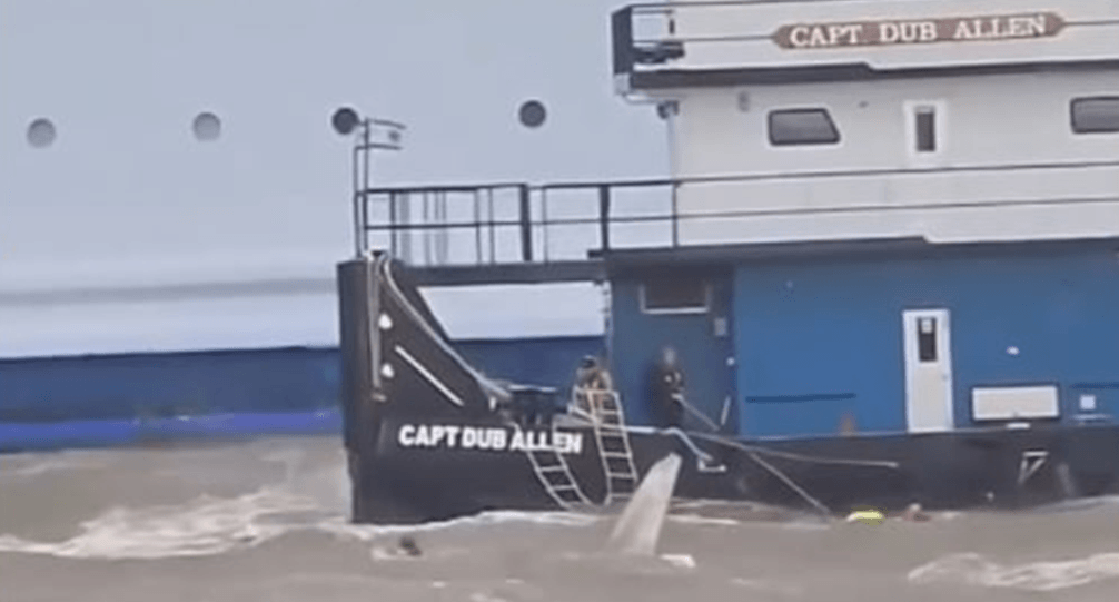 Tugboat rescuing people in ocean