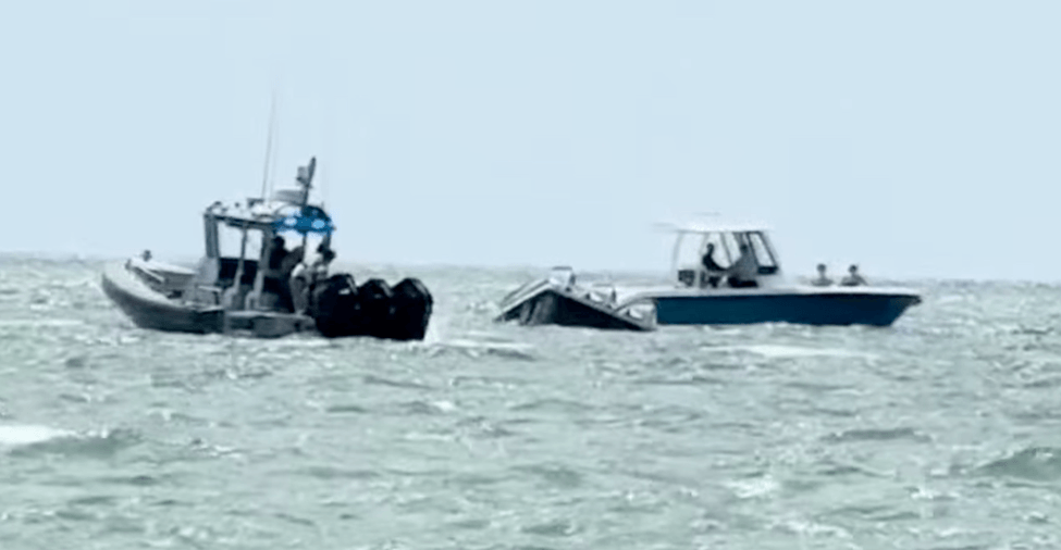 Crew helping an overturned boat