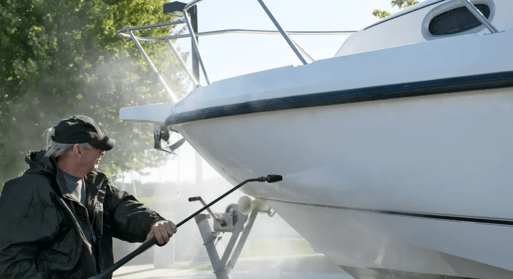 man cleaning boat