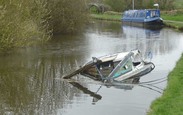 This one may be beyond insuring, but if your old boat still floats, you can probably find a company that will insure it. 