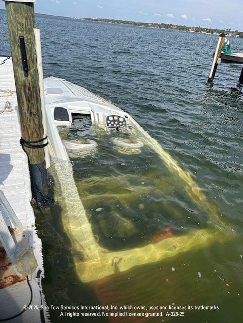 Boat tied to dock, submerged due to hurricane