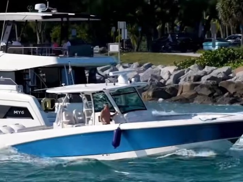 Boat in Haulover Inlet, captain leaves helm