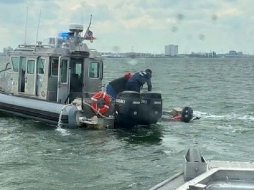 Chareslton harbor rescue in proccess with boat pulling people out of the water