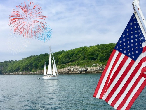 American flag, boat cruising in the background