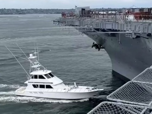 boat running into a large military ship