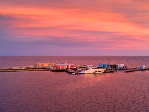 Night falls over Riviera 505 SUV Berry Sweet and the shacks where the Yewers family moored for a week