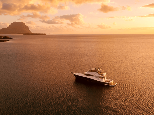 Riviera 72 Sports Motor Yacht Le Mercœur anchored off the dramatic coast of Mauritius