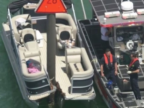 Birds eye view of a Pontoon boat crashed into a chanel marker