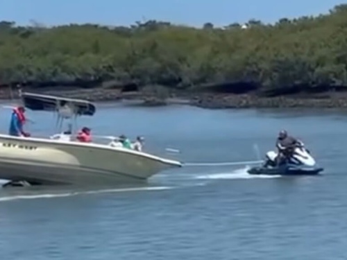 boat being pulled by jetski