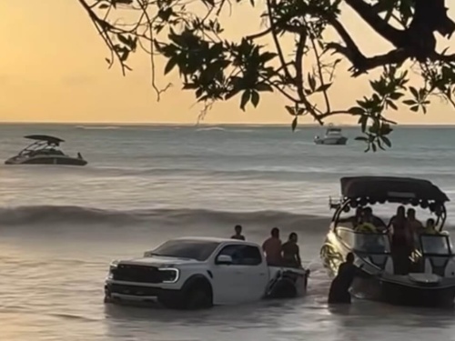 truck and boat getting rocked by waves