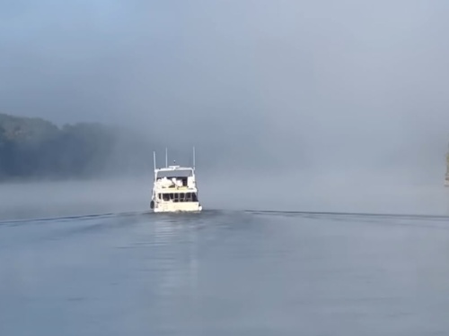 Boat riding through misty waters