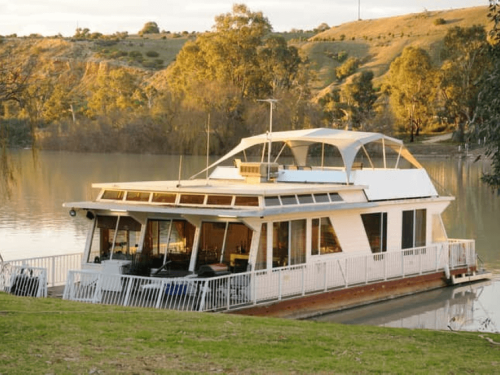 houseboat at sunset docked on river murray in south Australia