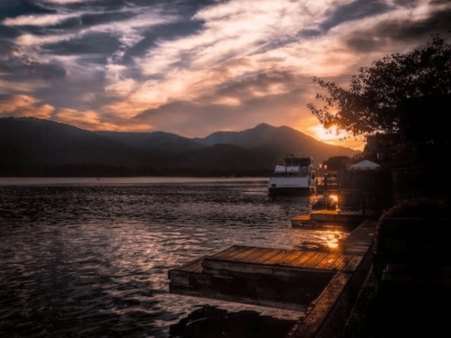 houseboat on the water at sunset