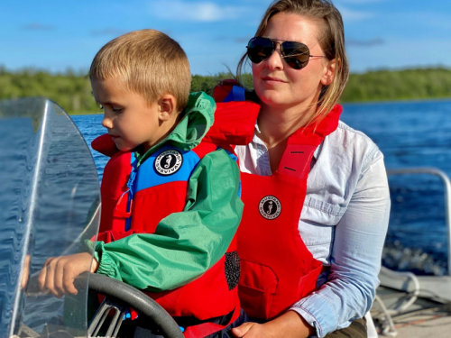 Mother and child lifejackets, mom and son driving boat
