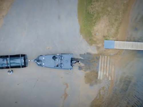 Truck pulling boat on trailer out of water
