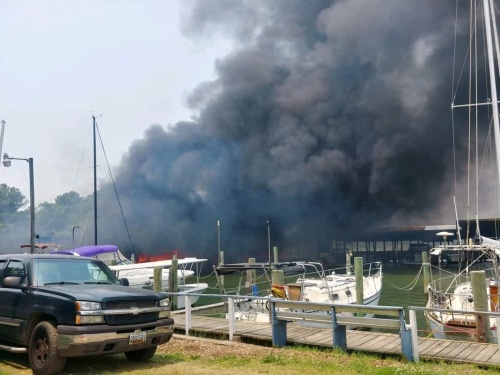 Covered pier and boats burn at marina