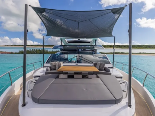 Pearl 72, the foredeck has a wide sofa and a sunpad that wraps around a folding table