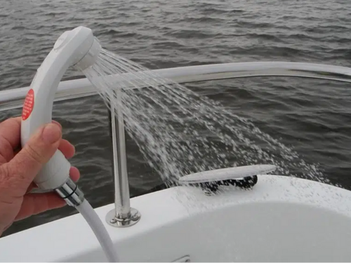 Aft deck freshwater shower sprays while the boat is in open water