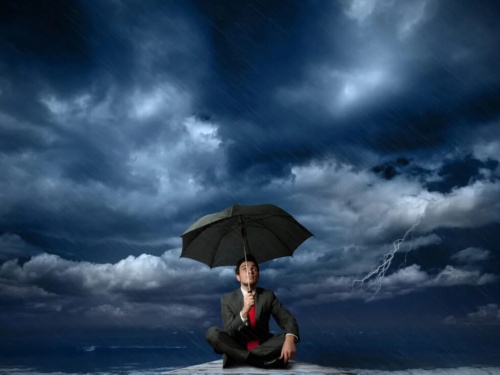 Man with umbrella on a stormy night on the water