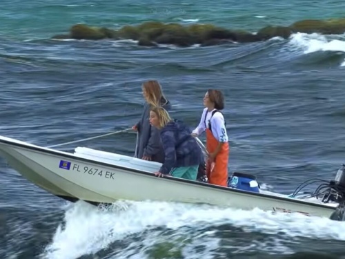 kids at the helm of boat
